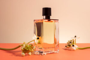 A beautiful perfume bottle and flowers on the table
